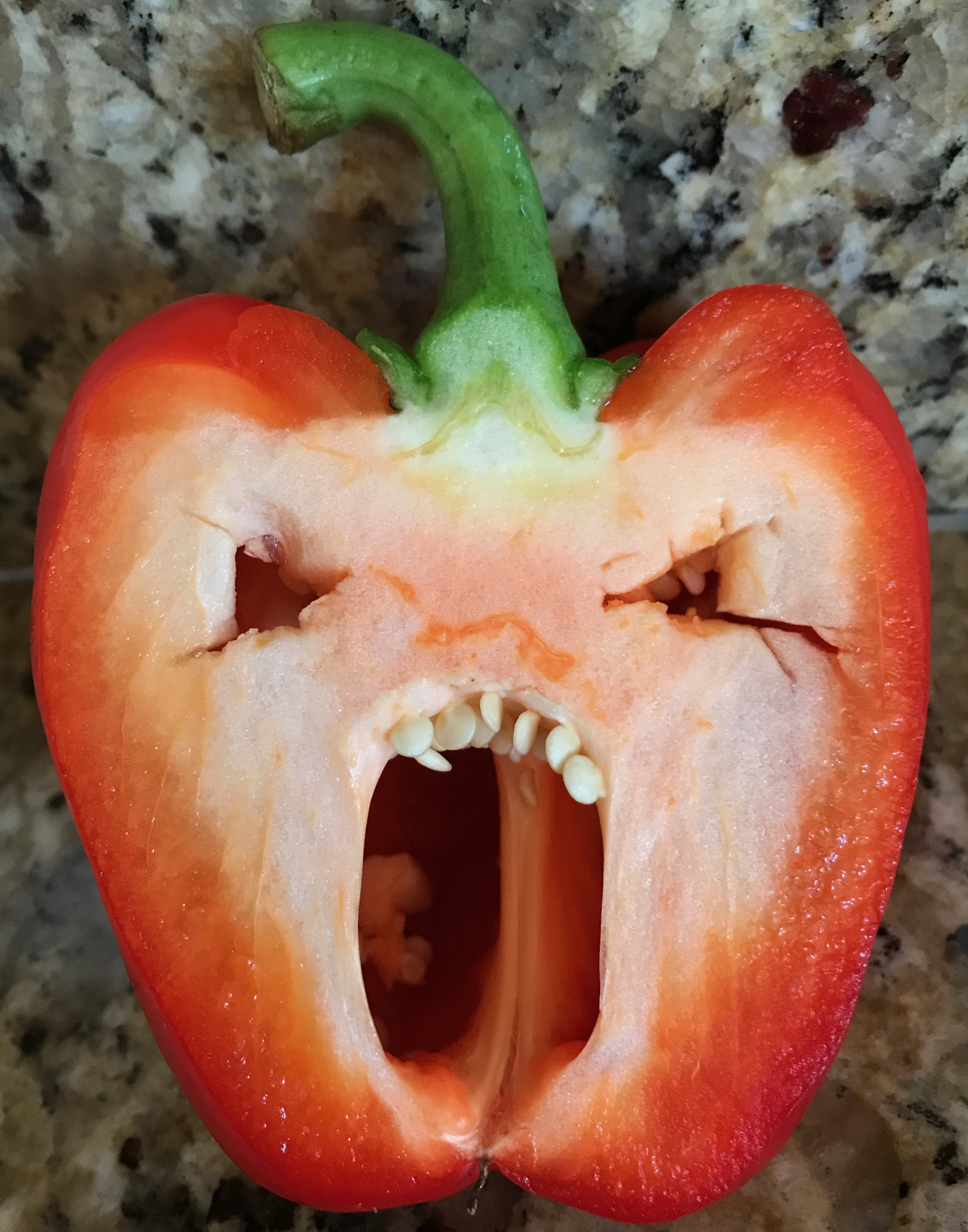 Pepper with an angry face carved into it